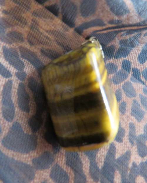 Large genuine tigereye pendant size 4.5cm x 2.5cm. New condition.