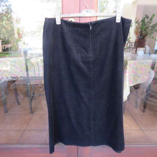 Warm black corduroy A-line band less skirt. One cute pocket. Zip at back. By DONATELLA size 46/22.