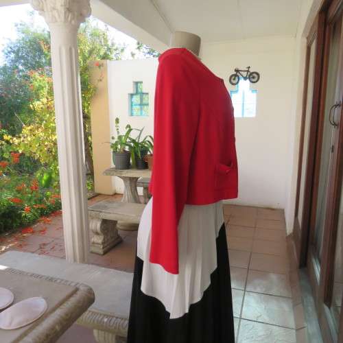 Cherry red long sleeve warm viscose/poly stretch cropped jacket.Button down front. Size 38. New cond