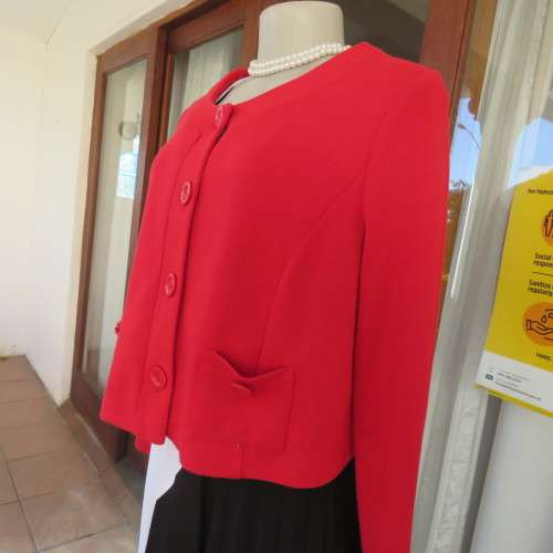 Cherry red long sleeve warm viscose/poly stretch cropped jacket.Button down front. Size 38. New cond
