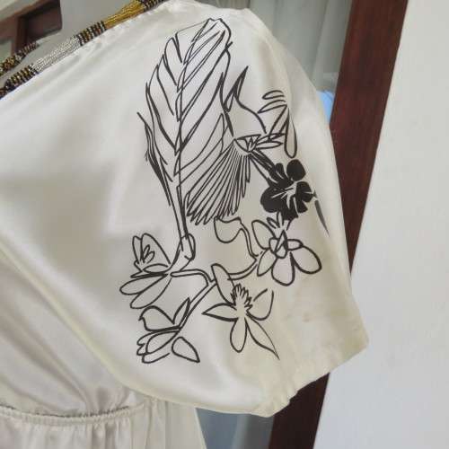 Silky rich cream satin empire top with black floral/bird print. Size 36 by RT.Elasticated under bust