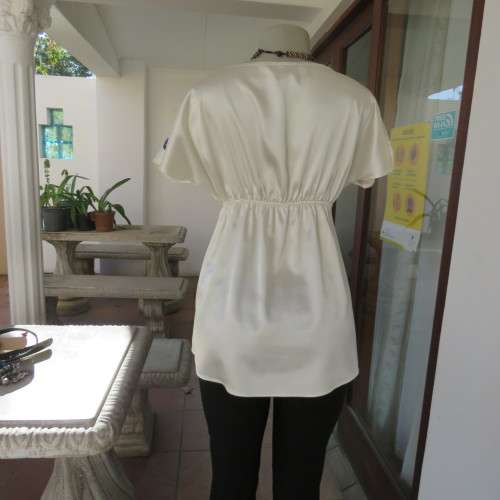 Silky rich cream satin empire top with black floral/bird print. Size 36 by RT.Elasticated under bust