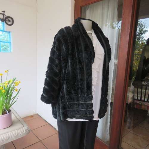 Vintage DE PARIS black faux fur jacket. Size 40. Elbow sleeves. Kangaroo pockets. Open front.