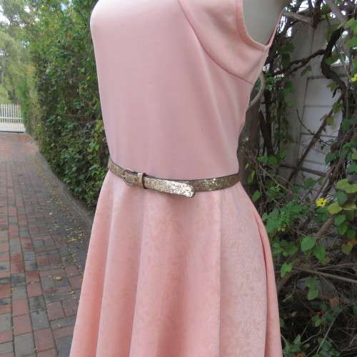 Sweet light peach stretch polyester skater style sleeveless dress by RT in size 36/12. Low back.