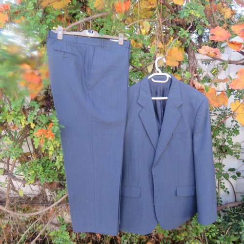 As new steel blue/subtle check 2 pc check suit by PETROCELLI in trevira/wool. Jacket 44R.Pants 38.