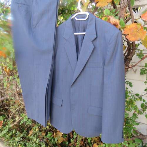 As new steel blue/subtle check 2 pc check suit by PETROCELLI in trevira/wool. Jacket 44R.Pants 38.