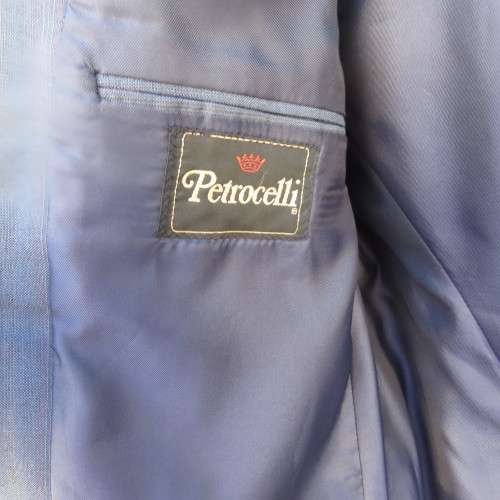 As new steel blue/subtle check 2 pc check suit by PETROCELLI in trevira/wool. Jacket 44R.Pants 38.