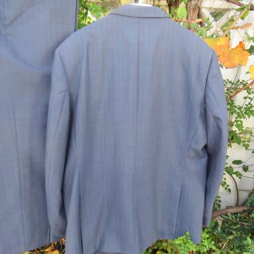 As new steel blue/subtle check 2 pc check suit by PETROCELLI in trevira/wool. Jacket 44R.Pants 38.