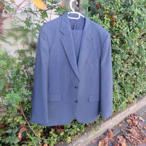 As new steel blue/subtle check 2 pc check suit by PETROCELLI in trevira/wool. Jacket 44R.Pants 38.