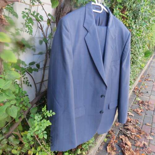 As new steel blue/subtle check 2 pc check suit by PETROCELLI in trevira/wool. Jacket 44R.Pants 38.