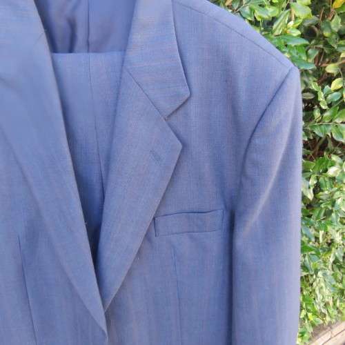 As new steel blue/subtle check 2 pc check suit by PETROCELLI in trevira/wool. Jacket 44R.Pants 38.