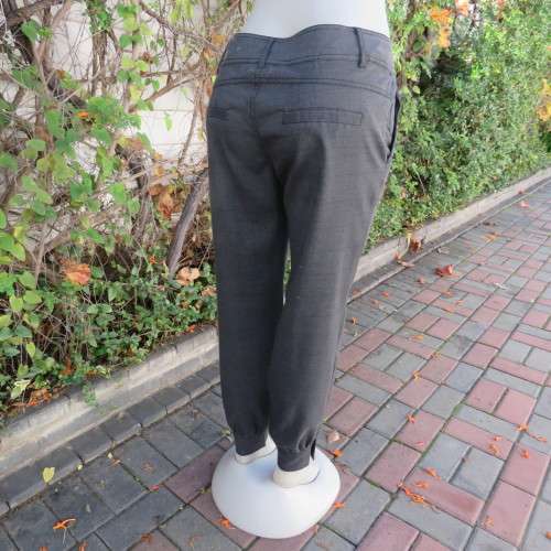 Perfect fit fine black/grey check size 34 low rise pants by LEGIT. Poly/rayon stretch. Leg cuffs.