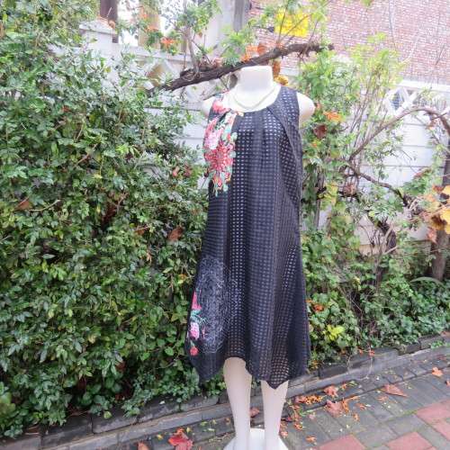 Cool black opaque check A-line dress with white lining. Bold floral design. Size 38 by JUDY,S PRIDE.