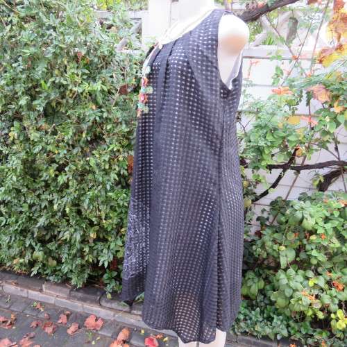 Cool black opaque check A-line dress with white lining. Bold floral design. Size 38 by JUDY,S PRIDE.
