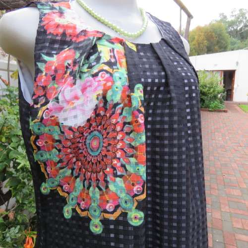 Cool black opaque check A-line dress with white lining. Bold floral design. Size 38 by JUDY,S PRIDE.