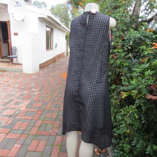 Cool black opaque check A-line dress with white lining. Bold floral design. Size 38 by JUDY,S PRIDE.