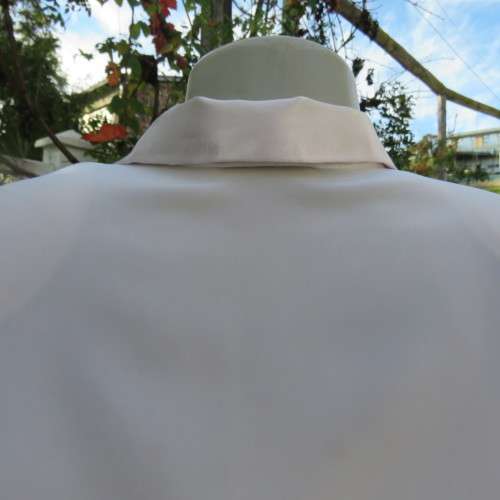 Smart long sleeve off-white top. Button down with satin covered buttons/shirt collar.Size 40. M.H.