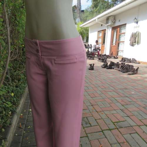 Dusty pink straight legged dress pants in rich polyester blends. Some stretch. Size 34/10. As new.