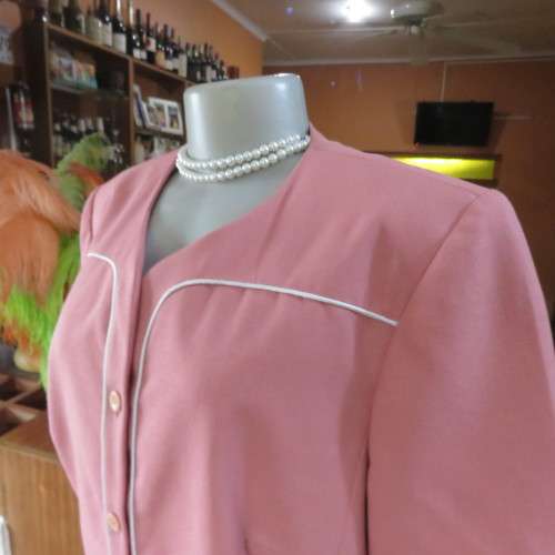 Smart hip length apricot colour short sleeve lined jacket with cream cord edging.Size 42 by MATSON
