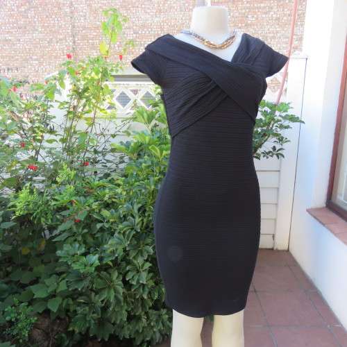 Stunning black stretch ribbed polyester dress.Capped sleeves.V with cross over detail.Size 32 AMERIE