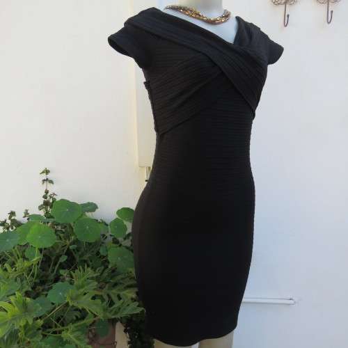 Stunning black stretch ribbed polyester dress.Capped sleeves.V with cross over detail.Size 32 AMERIE