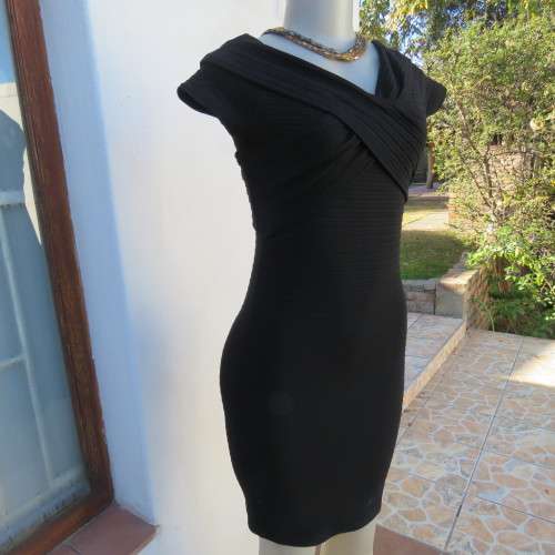 Stunning black stretch ribbed polyester dress.Capped sleeves.V with cross over detail.Size 32 AMERIE