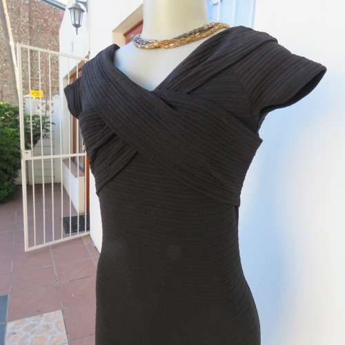 Stunning black stretch ribbed polyester dress.Capped sleeves.V with cross over detail.Size 32 AMERIE
