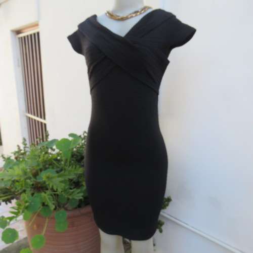 Stunning black stretch ribbed polyester dress.Capped sleeves.V with cross over detail.Size 32 AMERIE
