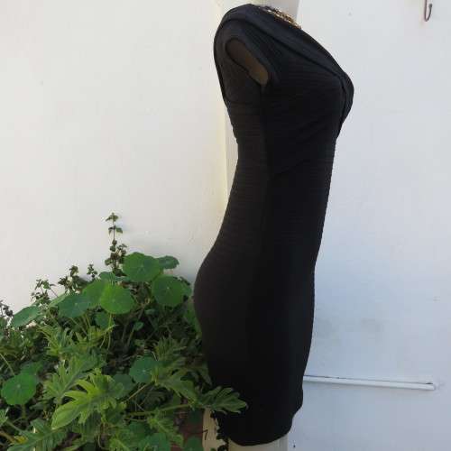 Stunning black stretch ribbed polyester dress.Capped sleeves.V with cross over detail.Size 32 AMERIE