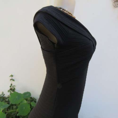 Stunning black stretch ribbed polyester dress.Capped sleeves.V with cross over detail.Size 32 AMERIE