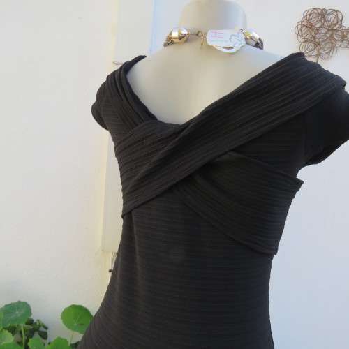 Stunning black stretch ribbed polyester dress.Capped sleeves.V with cross over detail.Size 32 AMERIE