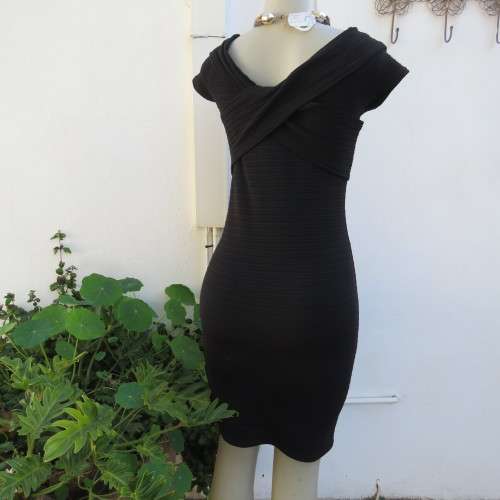 Stunning black stretch ribbed polyester dress.Capped sleeves.V with cross over detail.Size 32 AMERIE