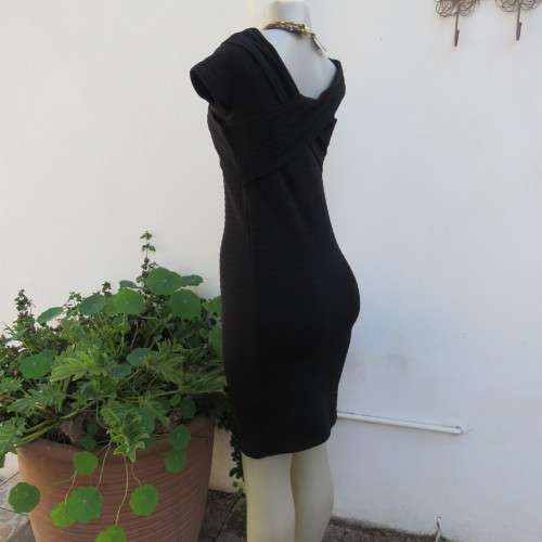 Stunning black stretch ribbed polyester dress.Capped sleeves.V with cross over detail.Size 32 AMERIE