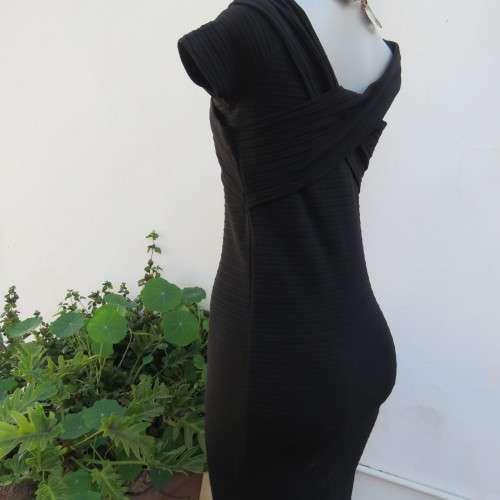 Stunning black stretch ribbed polyester dress.Capped sleeves.V with cross over detail.Size 32 AMERIE