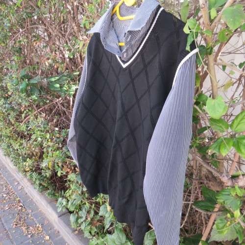 Men`s black acrylic knit pullover. Diamond pattern.White edging.Striped attached sleeved/collar.Med