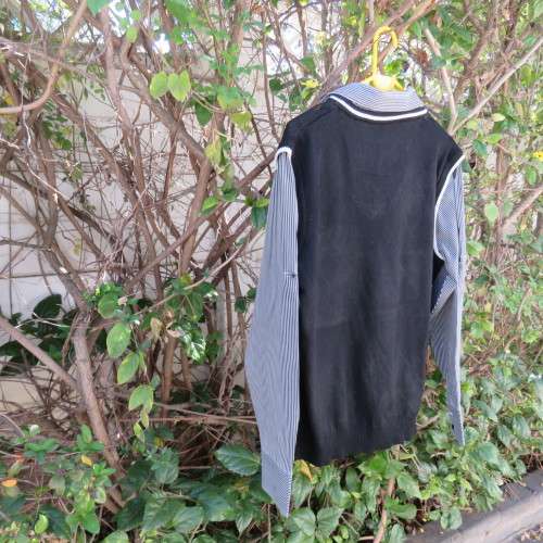 Men`s black acrylic knit pullover. Diamond pattern.White edging.Striped attached sleeved/collar.Med