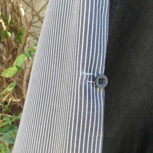Men`s black acrylic knit pullover. Diamond pattern.White edging.Striped attached sleeved/collar.Med
