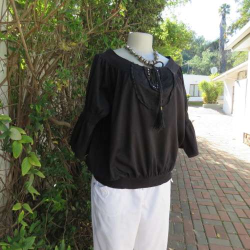 Pretty peasant style black 100% cotton top. Elasticated neckline and hemline. Size 40/16.WOOLWORTHS