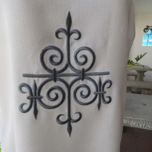 High quality long textured cream polyester top. Sleeveless. Exotic silver front embroidery. Size 36