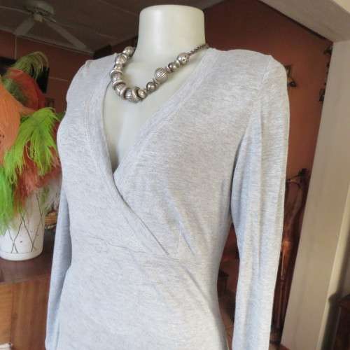 Silver grey long sleeve size 36/12 empire waist top with fold over bust. By JFK. Stretch viscose.