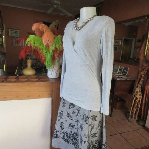 Silver grey long sleeve size 36/12 empire waist top with fold over bust. By JFK. Stretch viscose.