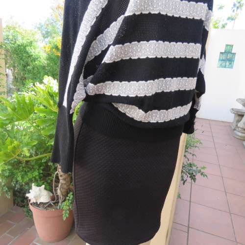 Unique black acrylic/cotton knitted kimono sleeve top with cream stripes. Scooped neckline.Size 36