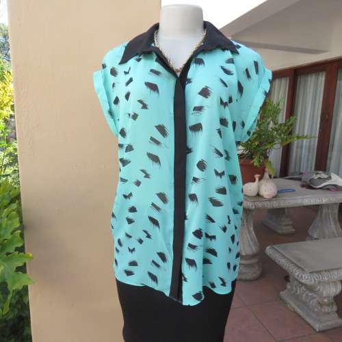 Cool sleeveless sheer turquoise poly top with black brush marks/collar/hidden button down.Size 36/12