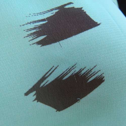Cool sleeveless sheer turquoise poly top with black brush marks/collar/hidden button down.Size 36/12
