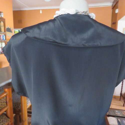Lovely black silky polyester button down top. Tiny cut-on sleeves. Wide pointed collar. Size 40/16.