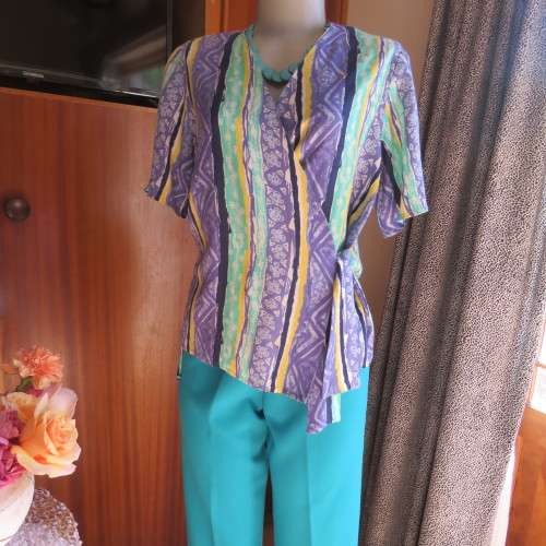 Beautiful fold over 80`s top in 100% viscose. Blue/green/yellow pattern stripes. Ties at side. 36