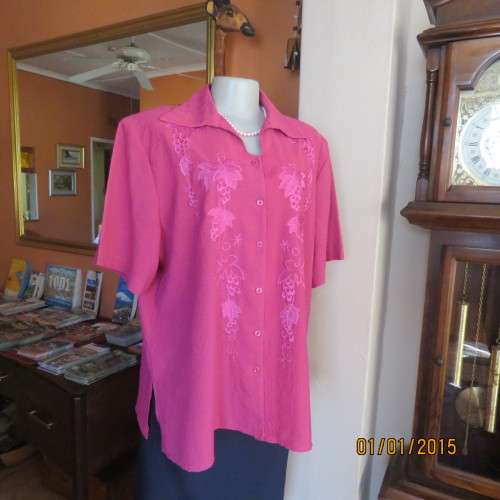 Top of the line magenta pink richly embroidered short sleeve bubble polyester top. Size 46. As new