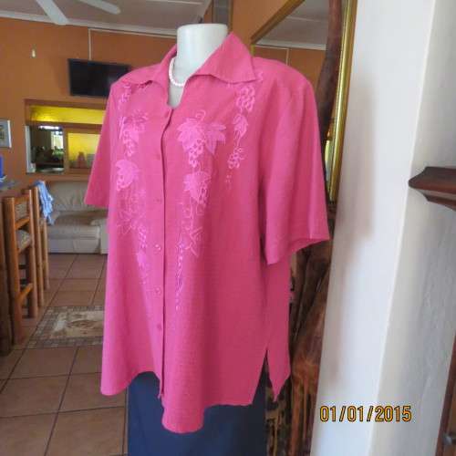 Top of the line magenta pink richly embroidered short sleeve bubble polyester top. Size 46. As new