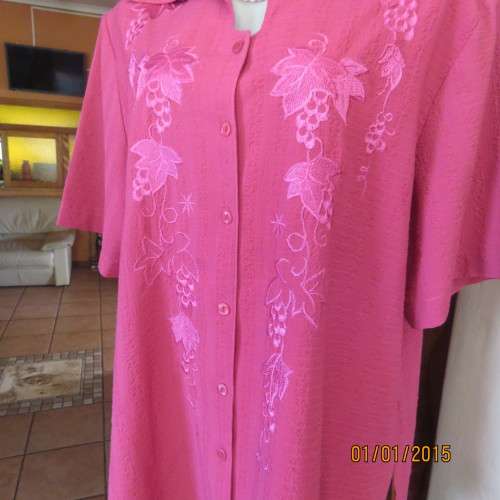 Top of the line magenta pink richly embroidered short sleeve bubble polyester top. Size 46. As new