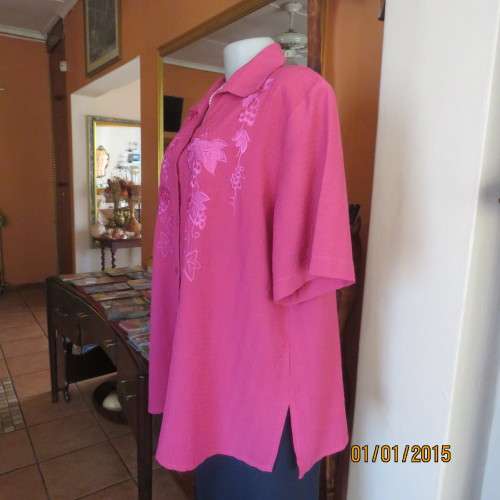 Top of the line magenta pink richly embroidered short sleeve bubble polyester top. Size 46. As new
